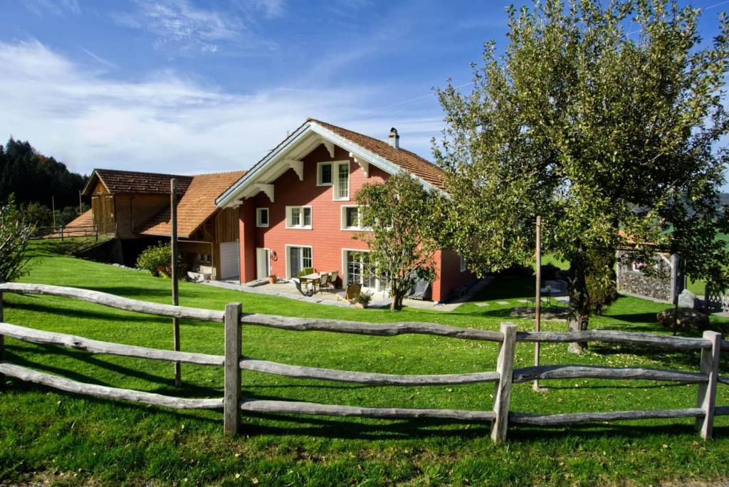 a wooden fence in front of a house at Ferienhaus Hörli in Sankt Peterzell