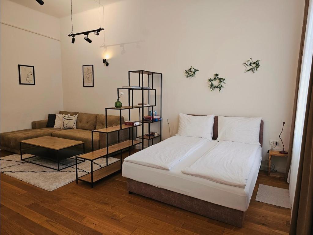 a bedroom with a bed and a couch at ELEVEN APARTMENT - Very Center - Free Parking in Osijek