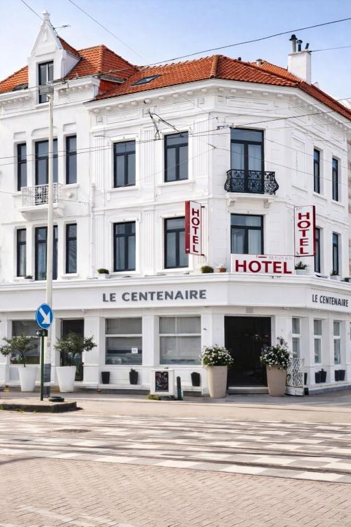 a white building with a hotel on a street at Hotel Le Centenaire Brussels Expo in Brussels
