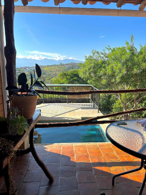a patio with a table and a swimming pool at Casa Castañeto Barichara in Barichara