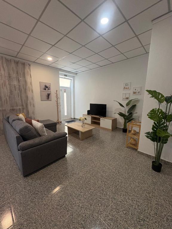 a living room with a couch and a tv at Casa São Marcos II in Peniche