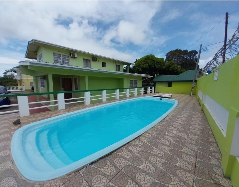 a villa with a swimming pool in front of a house at Pascall's Luxury Homes Villa in Lambeau