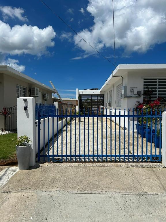 a blue fence in front of a house at Cozy West Coast Studio in Cabo Rojo