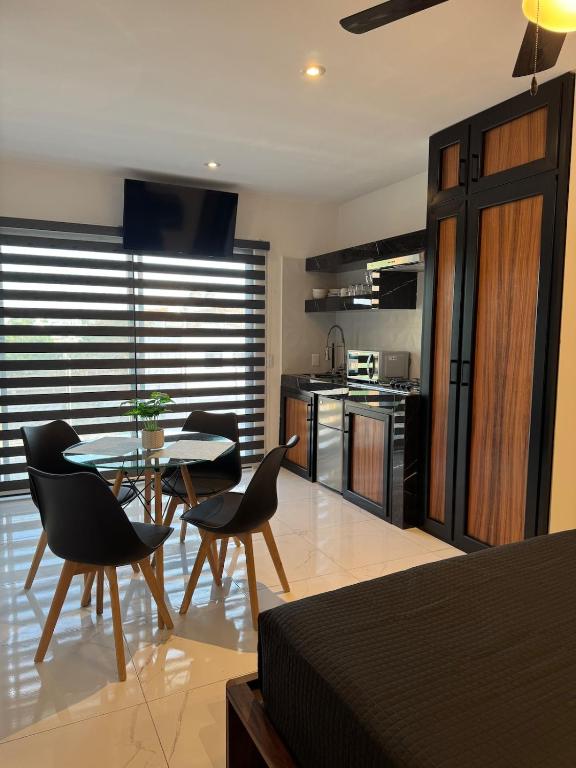 a kitchen and dining room with a table and chairs at Loft with Private Terrace in Tepic