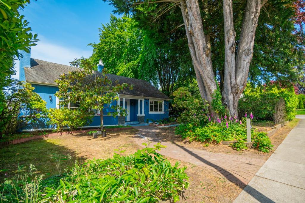 a blue house with a garden in front of it at 7811 The Solace Vista in Vancouver