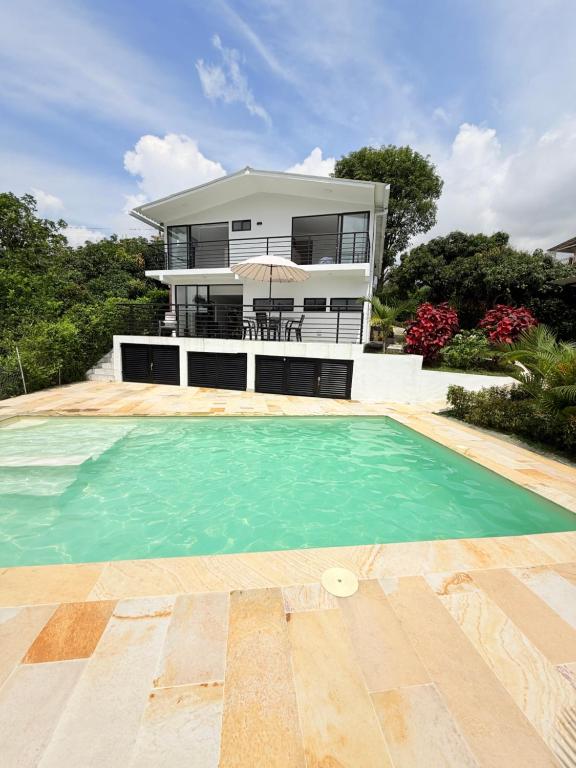 a house with a swimming pool in front of a house at Villa Verde in Silvania