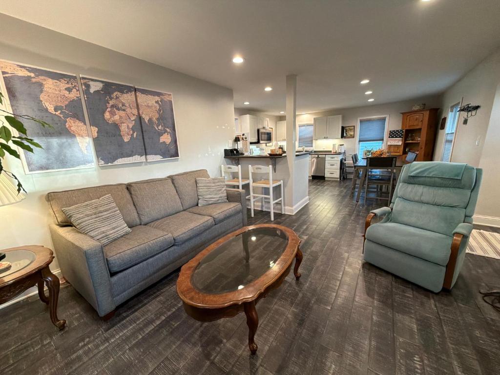 a living room with a couch and a table and chairs at The Dollar House in Albert Lea