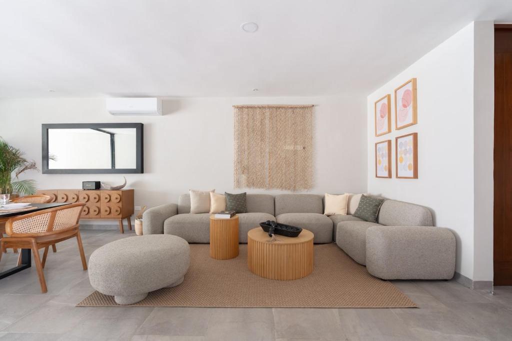 a living room with a couch and a table at Casa Kaybe in Tulum