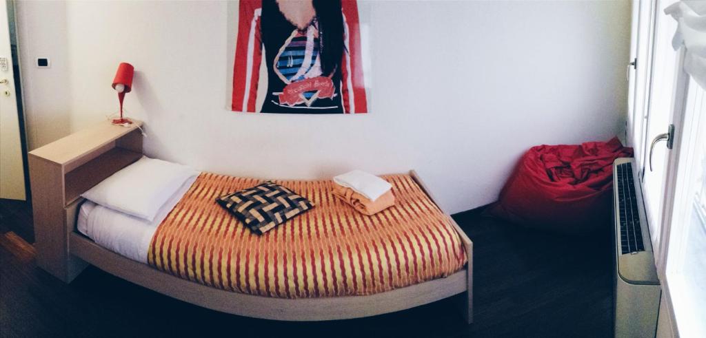A bed or beds in a room at IL CASTELLO HOSTEL BOUTIQUE