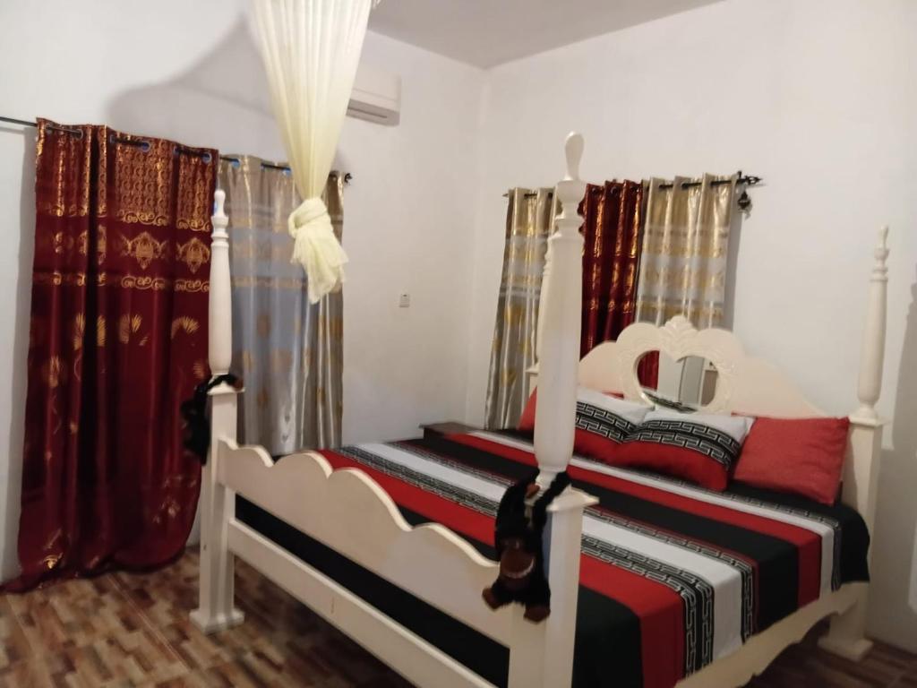 a bedroom with two beds with red and black at The Gibson's Palace in Ocho Rios