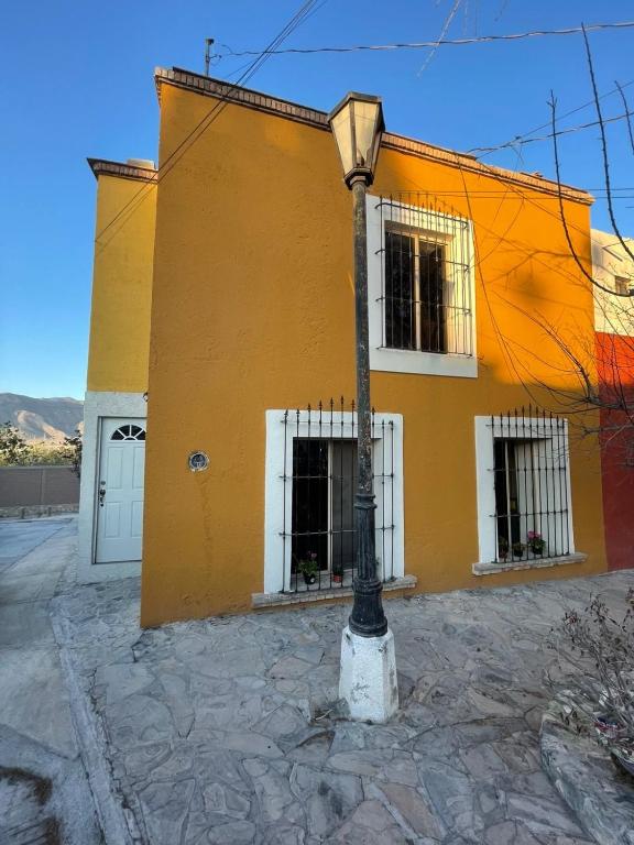a street light in front of a building at Yellow House, Private Apartment, Centro Arteaga in Arteaga