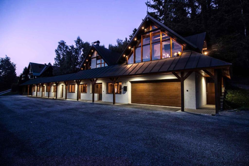 a large house with a garage at night at Studio with Pool in Benecko-Riesengebirge 2218 in Benecko