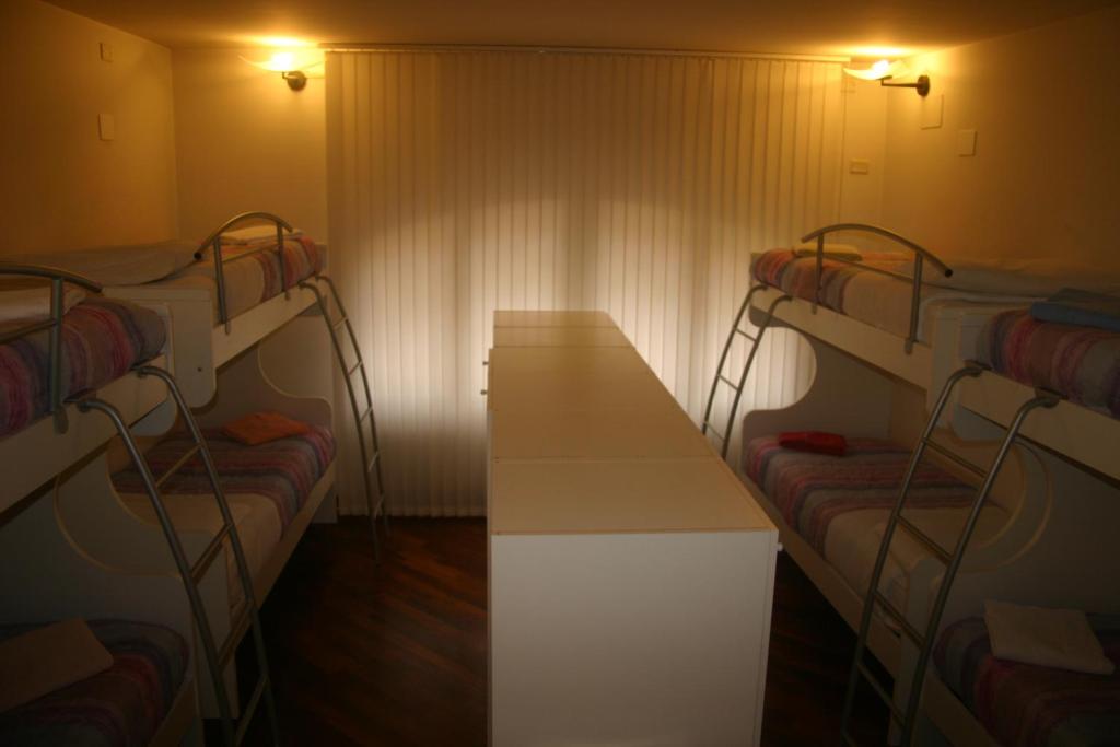 A bed or beds in a room at IL CASTELLO HOSTEL BOUTIQUE