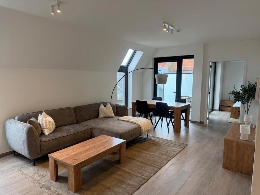 a living room with a couch and a table at City apartment with terrace in Hasselt