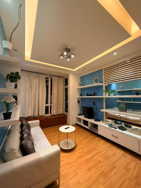 a living room with a couch and a table at Klcc Cozy Unit in Kuala Lumpur