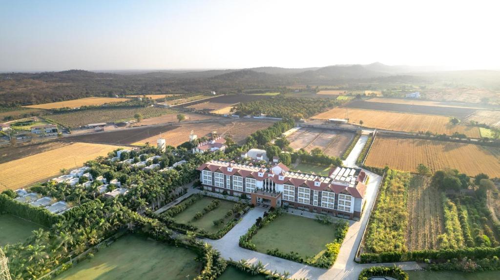 an aerial view of a building and a field at Radisson Resort & Spa Sasan Gir in Junagadh