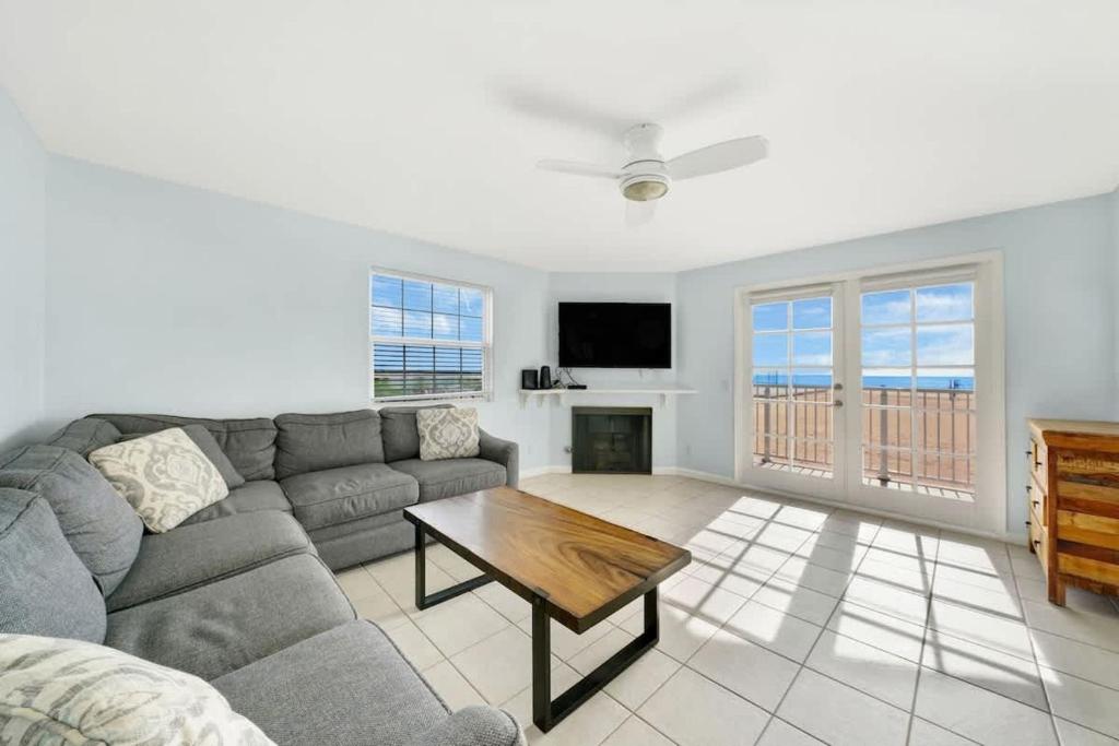 a living room with a couch and a table at Ocean and Scenic Beach Views From Deck apts in Newport Beach