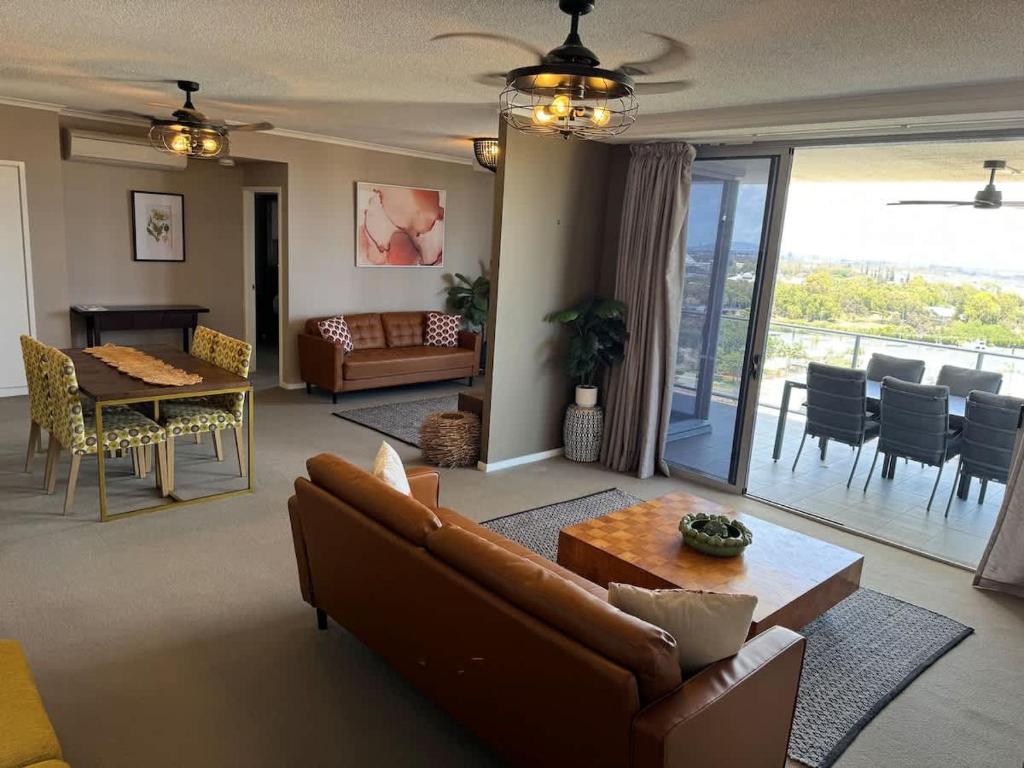 a living room with a couch and a table at The Perfect Host @ Curtis Apartments in Gladstone