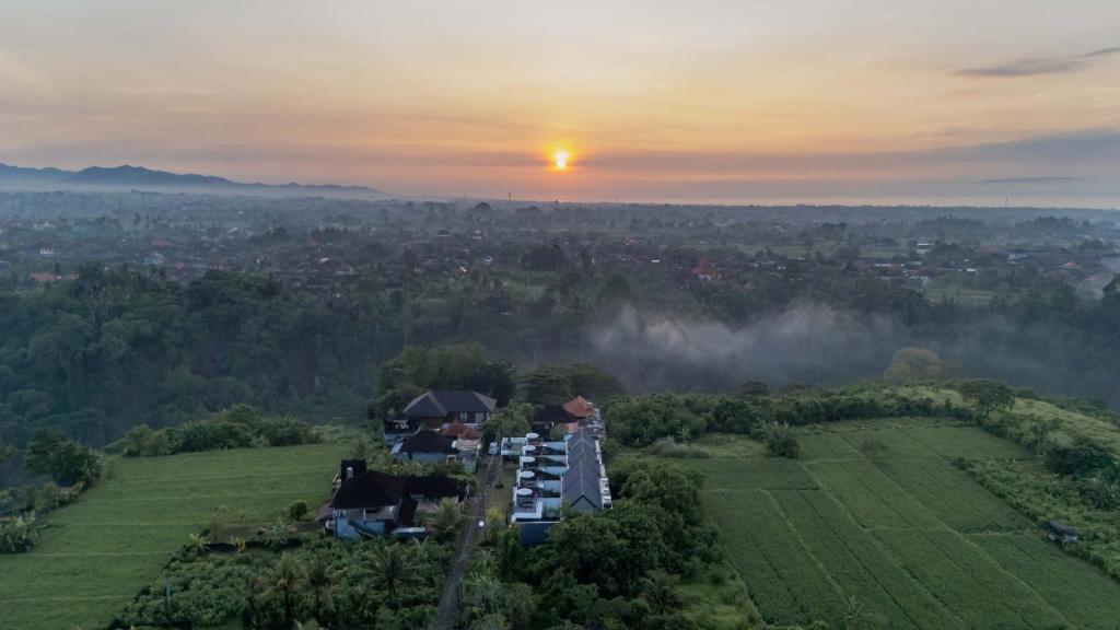 an aerial view of a house on a hill at sunset at Alima Villa Ubud in Ubud