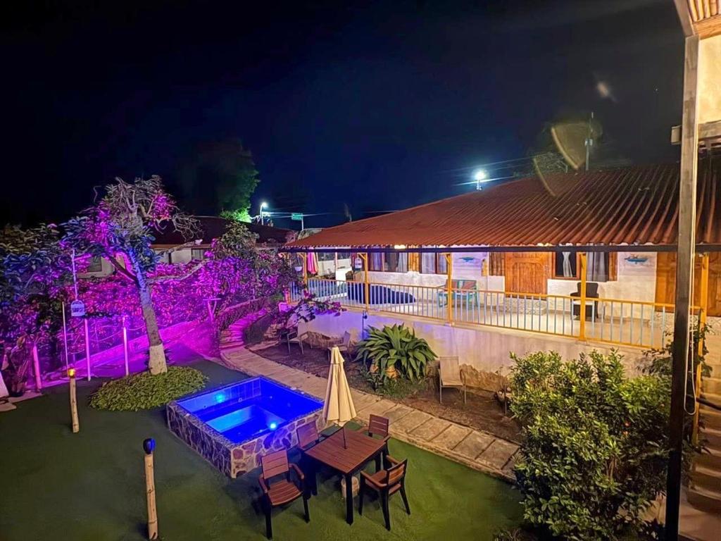 an overhead view of a house with a swimming pool at night at Hotel La Casona Quindío Eje Cafetero in Montenegro