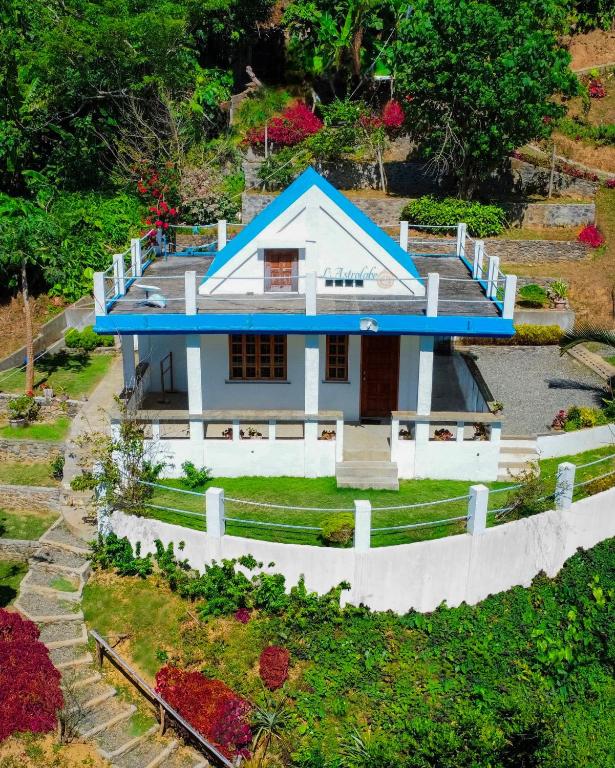a model of a house with a blue roof at L'Astrolabe - Ocean View Tiny House in Baras