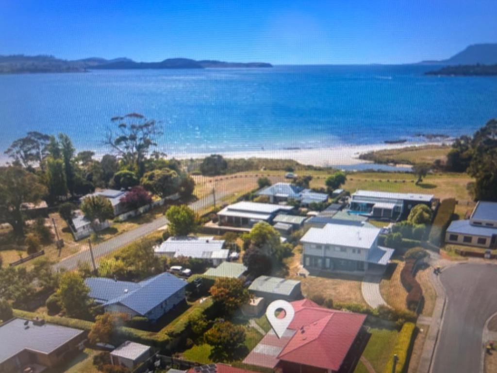 an aerial view of a town next to the ocean at Millingtons Beach House in Orford