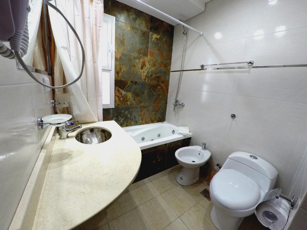 a bathroom with a sink and a toilet at Cabañas Victoria in Mar de las Pampas