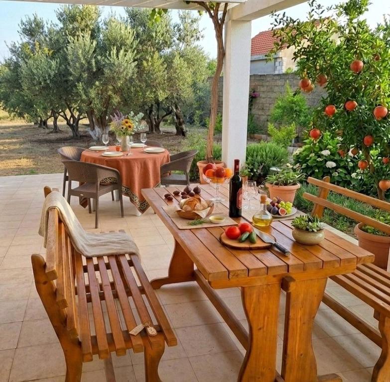 a wooden table and chairs on a patio at Pirshagi Villa in Baku