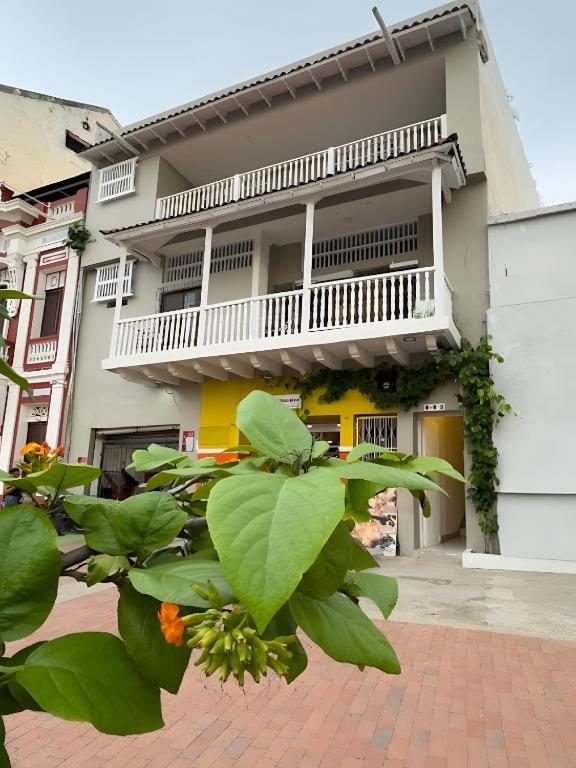 a building with a balcony and a plant at Casa Agena in Cartagena de Indias