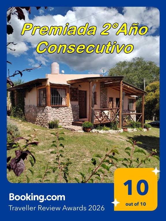 a house with a sign that reads premada auto crore at Cabañas Mónika III Norte in Huerta Grande