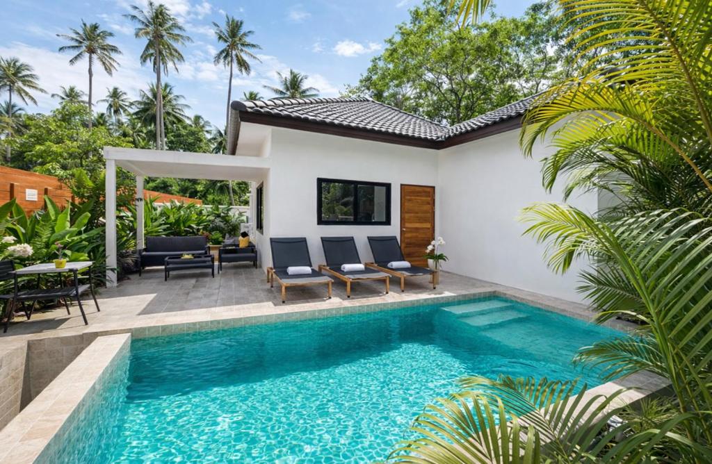 a swimming pool in front of a villa at Samui Kozy Private Pool Villa in Nathon Bay