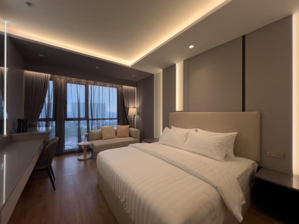a bedroom with a large white bed and a couch at The Aerie in Kuala Lumpur