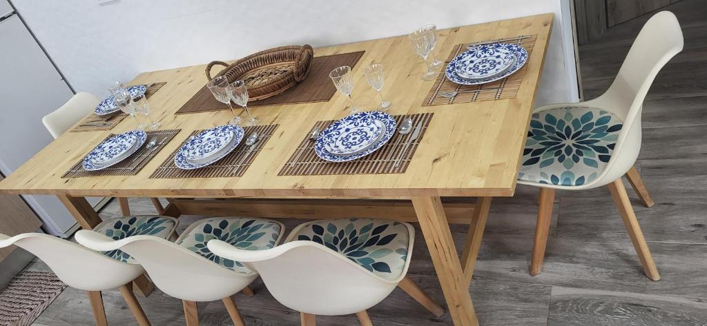 a wooden table with blue and white plates and chairs at Casa del Pilar in Pinto