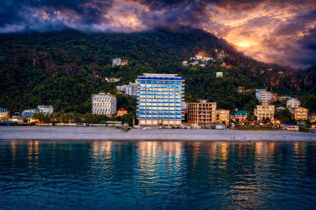a city on the shore of a body of water at Panoramic Sea Apartment in Kvariati