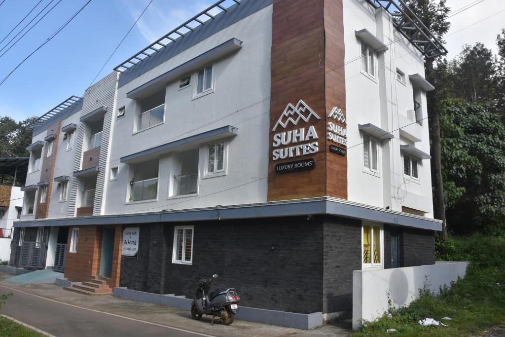 a building with a sign on the side of it at Bihotels And Resorts in Yercaud