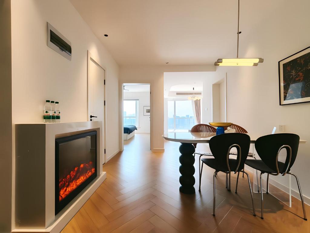 a living room with a table and a fireplace at Merit黄浦 Bright and Modern 2Bed Condo unit in downtown Shanghai in Shanghai