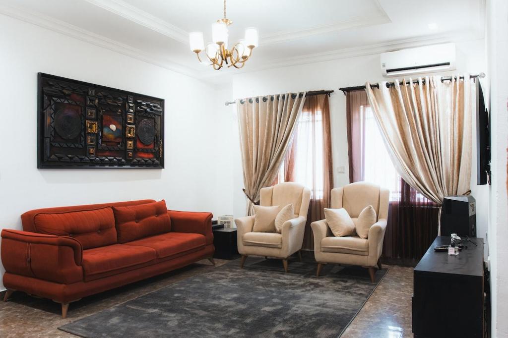 a living room with a couch and two chairs at Spacious 3-Bedroom in Central Ikeja in Ikeja