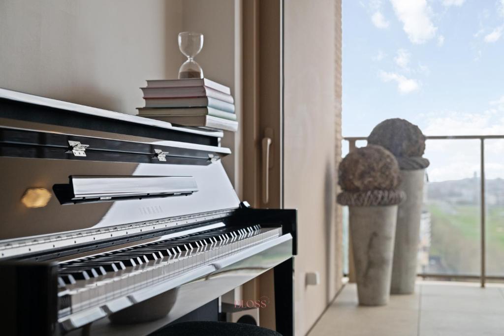 a piano in a living room with a window at Zilt 15 in Ostend