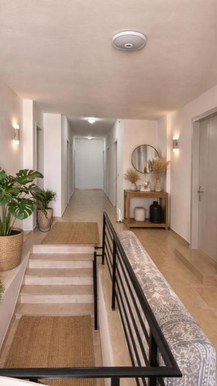 a hallway of a house with stairs and a mirror at Dublex Friendly apartaments perball Rafaelos in Shëngjin