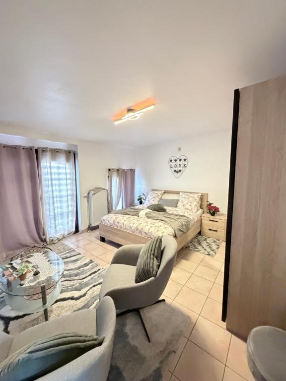 a bedroom with a bed and a couch and a table at Apartchrisbea in Namur