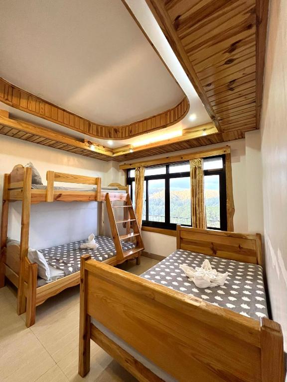 a room with two bunk beds in a house at Carpenters homestay in Sagada