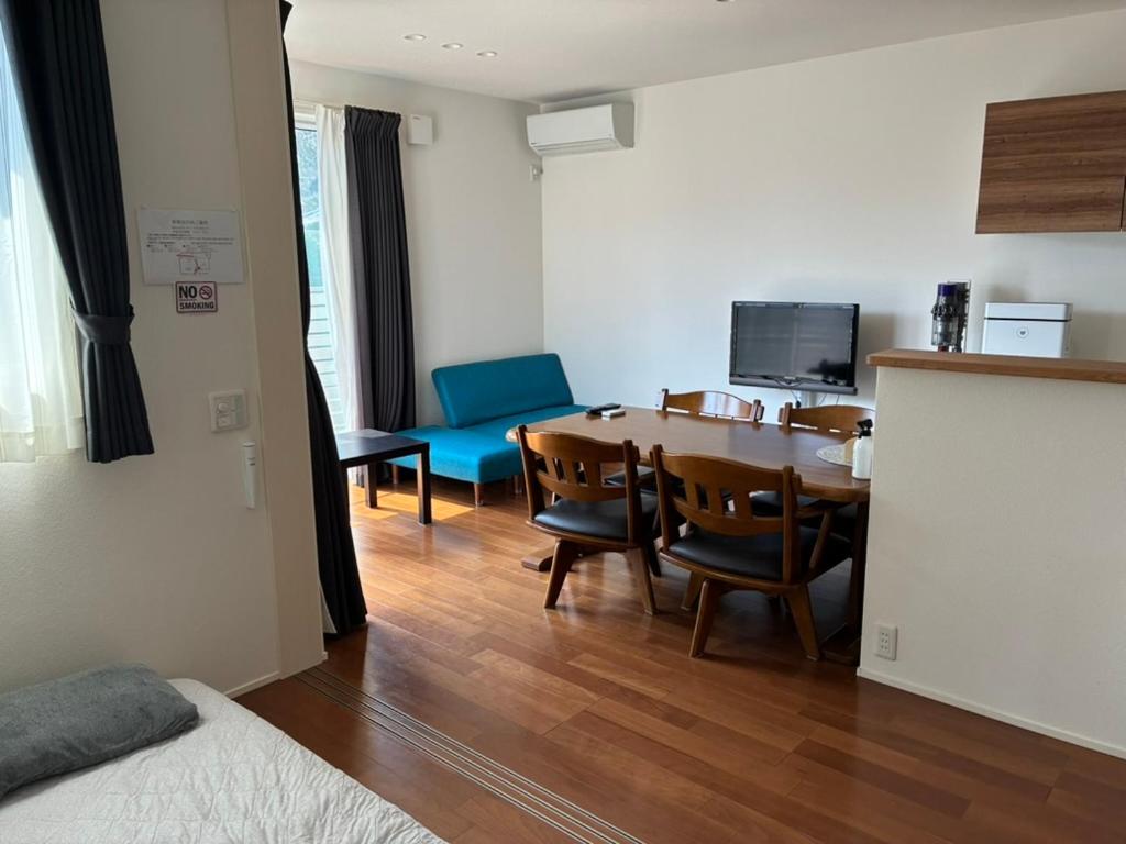 a room with a table and chairs and a dining room at Leaf Village in Tokorozawa