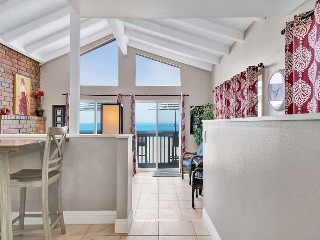a dining room with a view of the ocean at Oceanfront withIncredible Beach Views home in Newport Beach