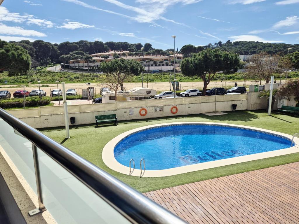 a balcony with a swimming pool and a parking lot at Belice 1-6 in Lloret de Mar