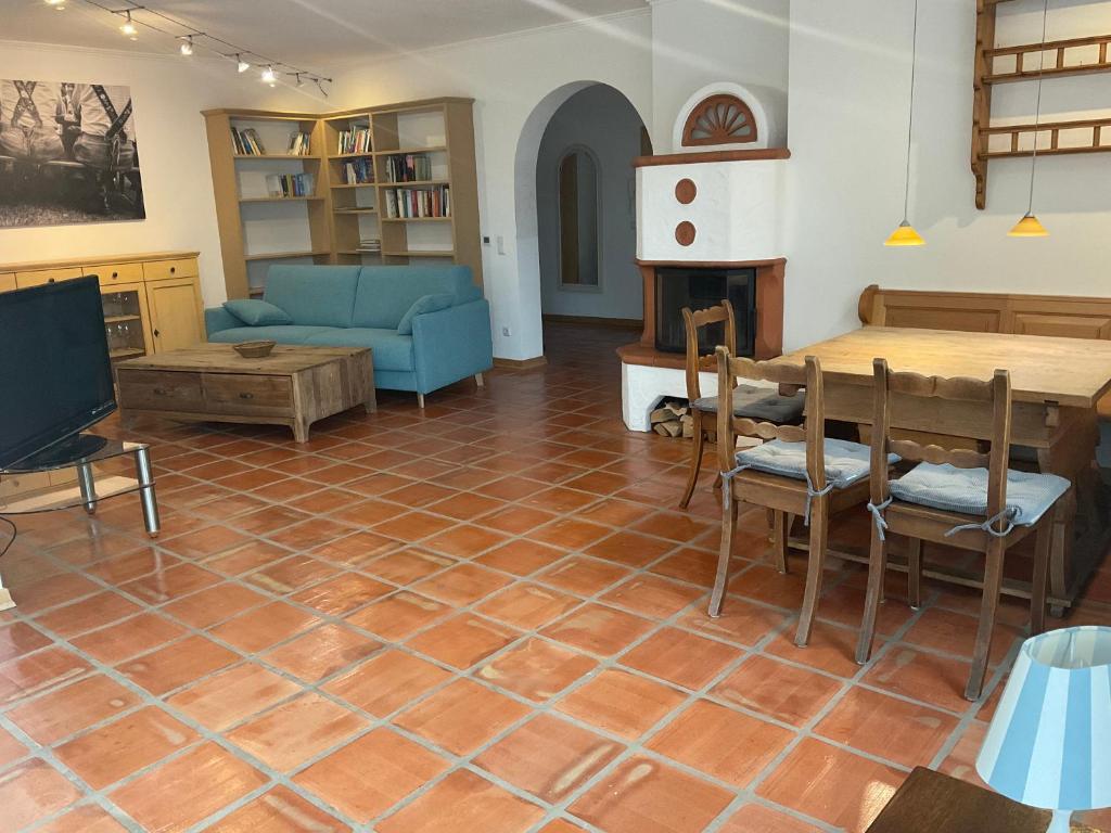 a living room with a tiled floor with a couch and a table at See & Natur Apartment Uffing in Uffing