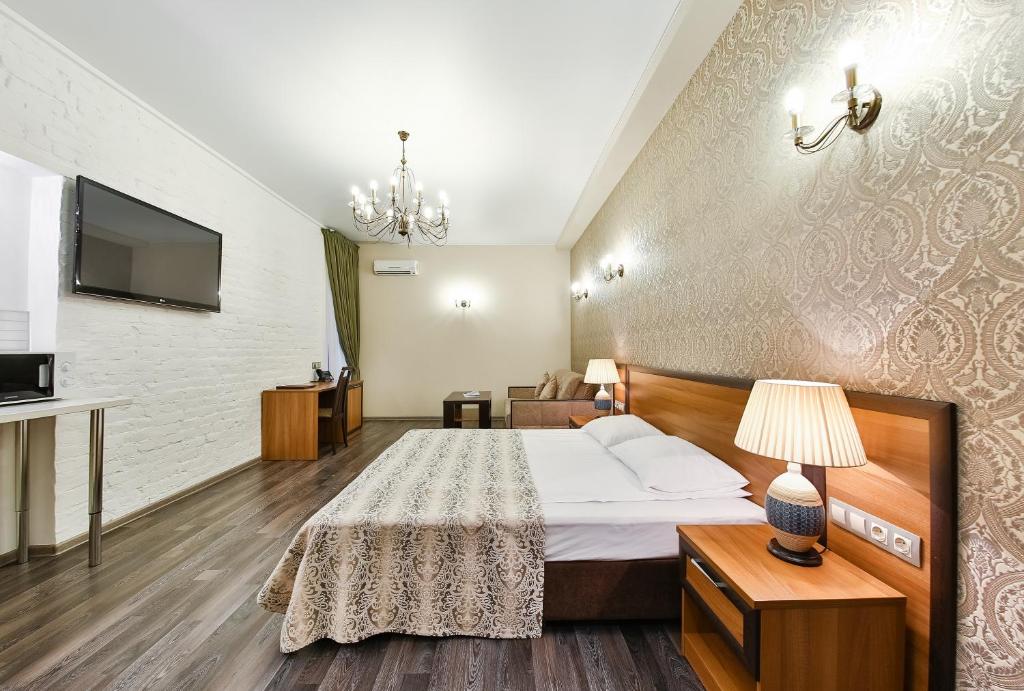 Postel nebo postele na pokoji v ubytování Allegro Ligovsky Prospekt