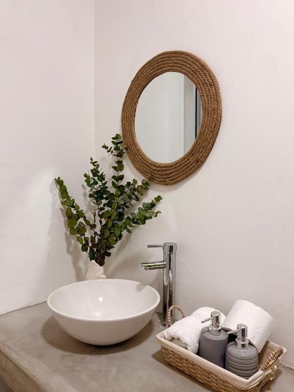 a bathroom with a white sink and a mirror at Bamboo in El Paredón Buena Vista