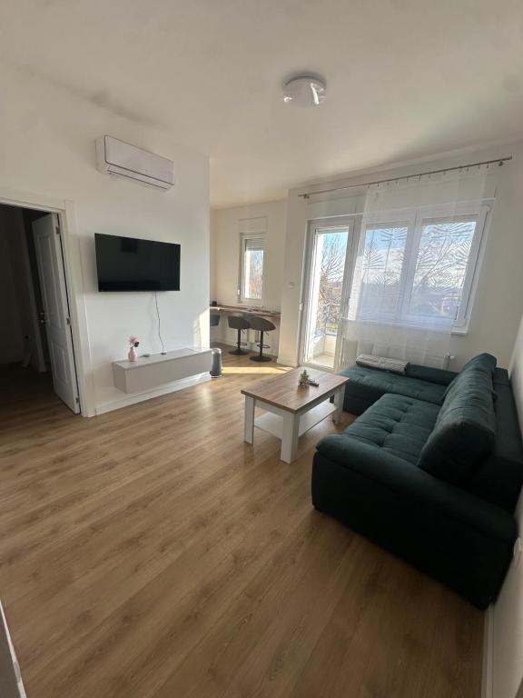 a living room with a couch and a table at Panonski Mornar in Palić