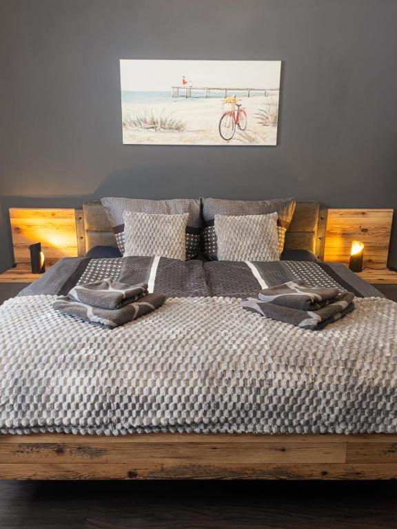a bedroom with a wooden bed with a picture of a beach at EDGE of FOREST in Titisee-Neustadt