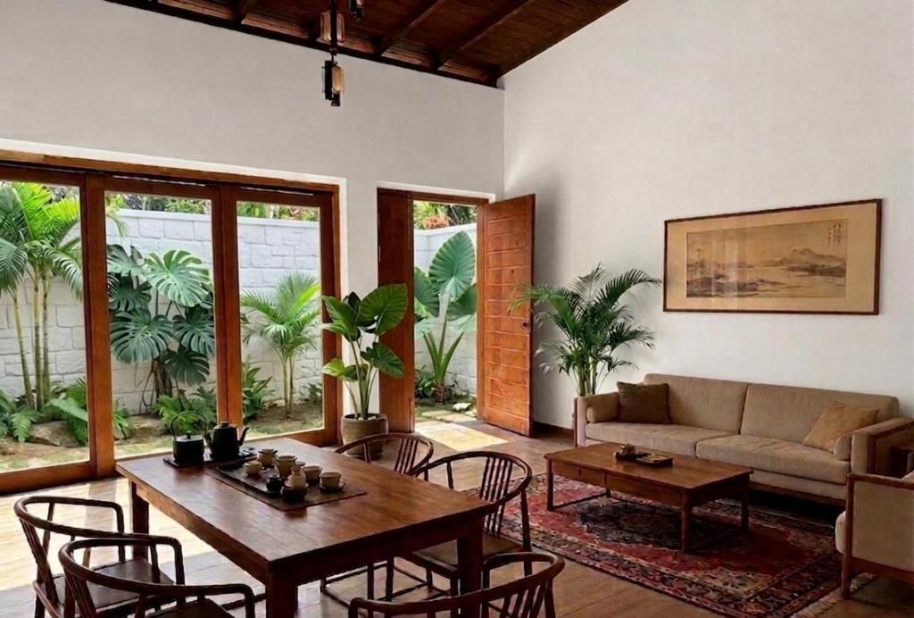 a living room with a couch and a table and chairs at Villa 55 Galle in Galle